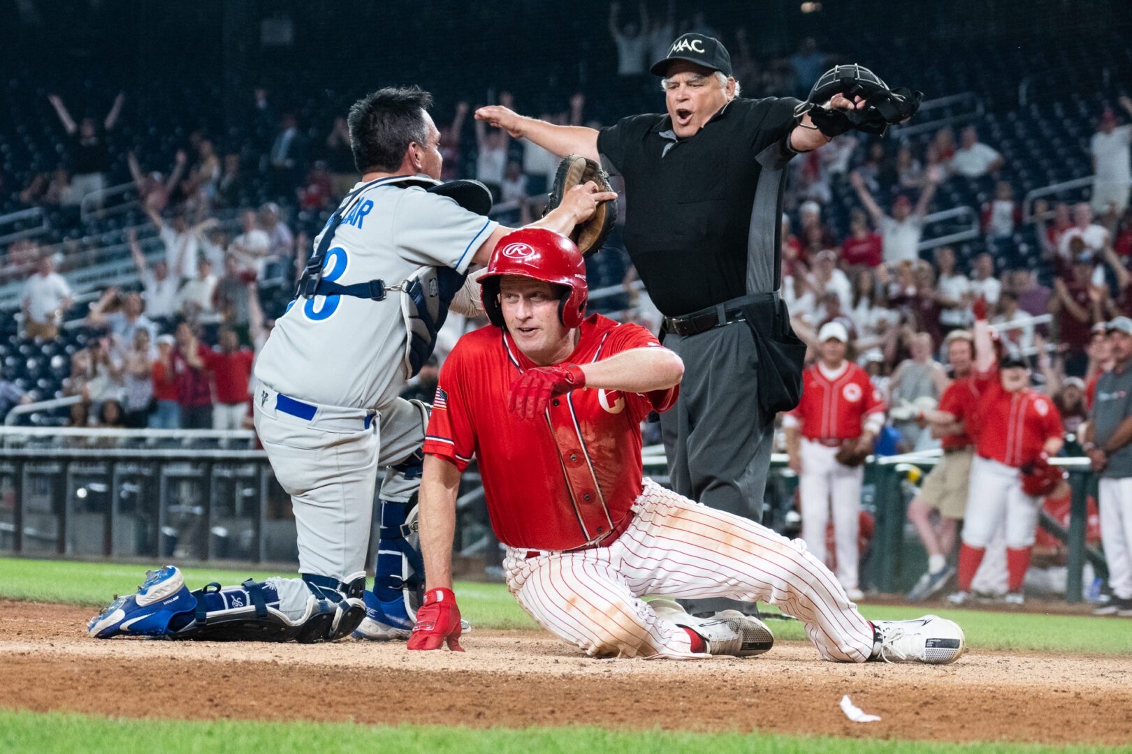 Rep. August Pfluger, R-Texas, slides in safe to home plate as catcher Rep. Pete Aguilar, D-Calif., appeals to the umpire during the Congressional Baseball Game on Wednesday. 