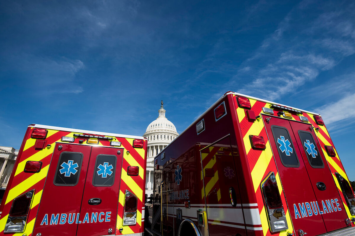 The Capitol is seen behind two ambulances in 2018. Congress should update its continuity planning to account for a new era, some lawmakers say. 