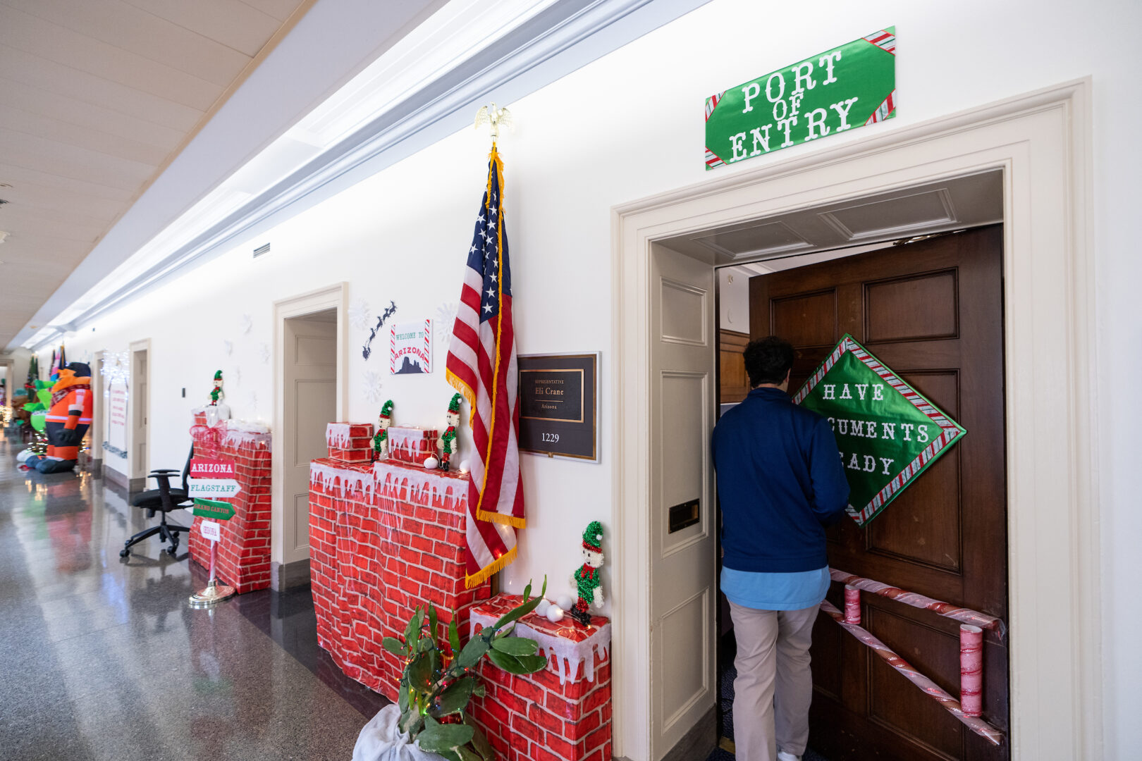 Border wall-themed holiday decorations hang outside the office of Rep. Eli Crane in the Longworth House Office Building this week. 