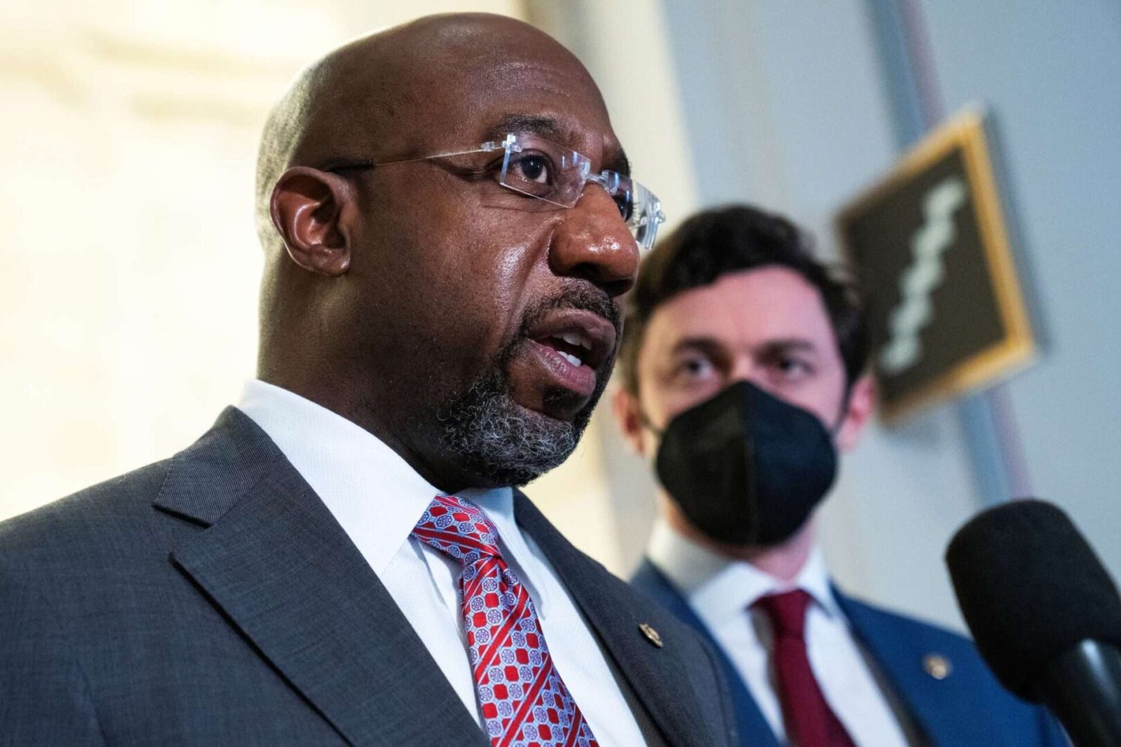 Sen. Raphael Warnock, left, said he hopes the Senate votes on his bill this month. Senate Majority Leader Charles E. Schumer has said only that the vote will come after the recess.