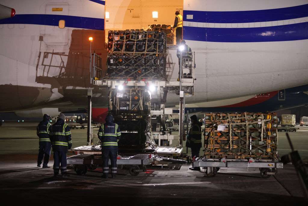 Ground personnel unload weapons, including Javelin anti-tank missiles, and other hardware from the U.S. military delivered on a National Airlines plane at Boryspil Airport near Kyiv on Jan. 25.