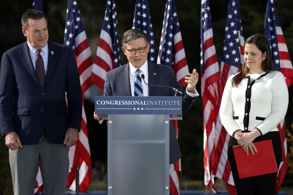 House Speaker Mike Johnson speaks as House Republican Conference Chair Elise Stefanik and National Republican Congressional Committee Chair Richard Hudson (L) listen during an “Expanding the Majority” press conference at The Greenbrier hotel.