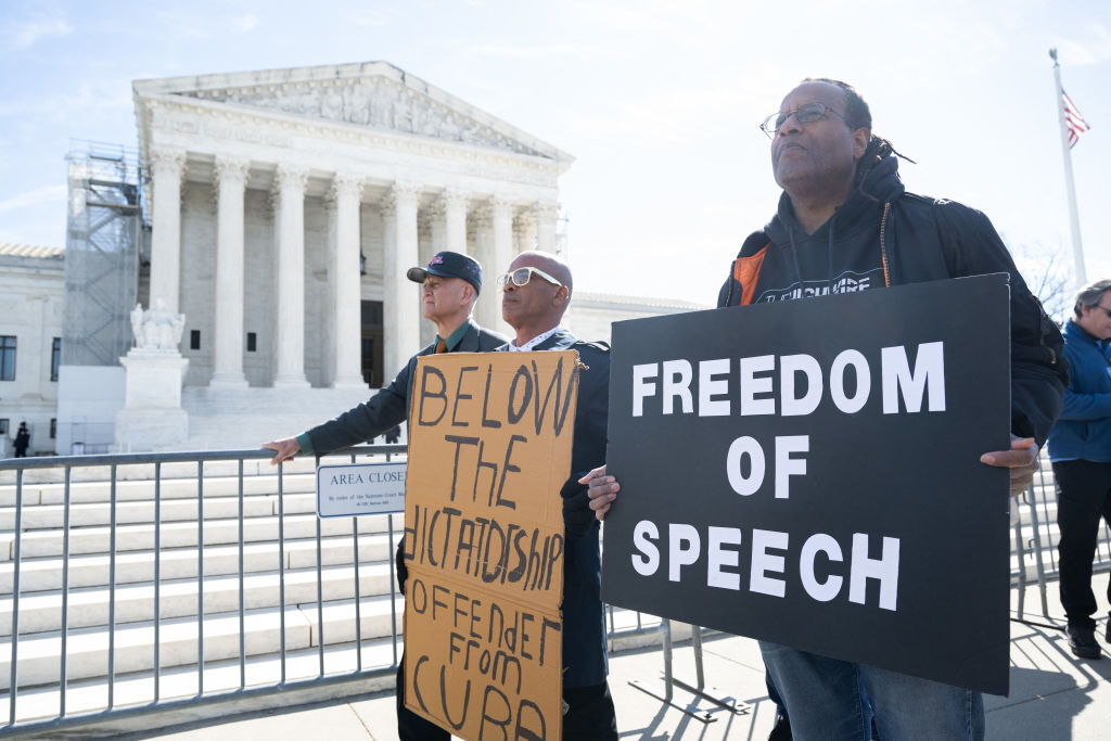 Conservative demonstrators protest outside the Supreme Court on Monday as the court hears oral arguments in the case of Murthy v. Missouri. 