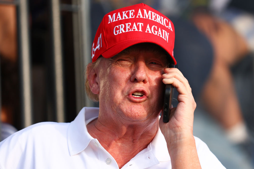 Former President Donald Trump speaks on the phone during day three of a LIV Golf tournament in Miami at Trump National Doral on Sunday. (Megan Briggs/Getty Images)