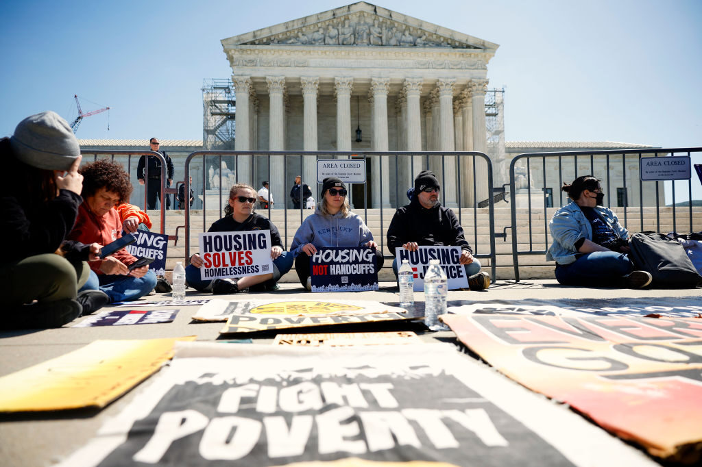 Homeless rights activists hold a rally outside of the  Supreme Court on Monday. The court heard oral argument in City of Grants Pass, Oregon v. Johnson, regarding ordinances that bar people who are homeless from camping on city streets.