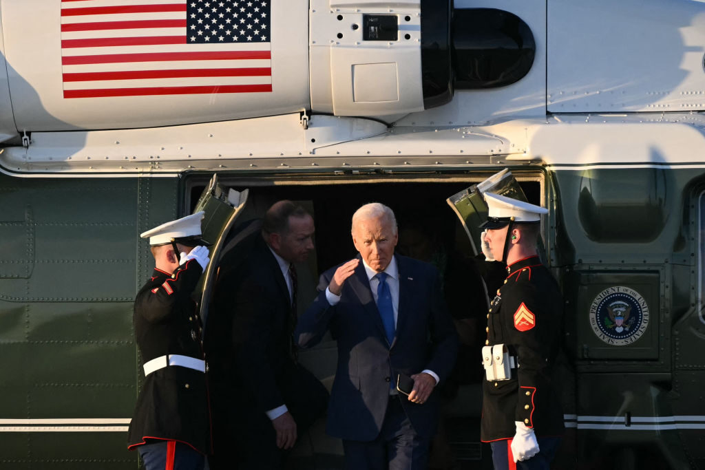 President Joe Biden salutes as he steps off of Marine One before departing Chicago O'Hare International Airport in Chicago on Wednesday. 