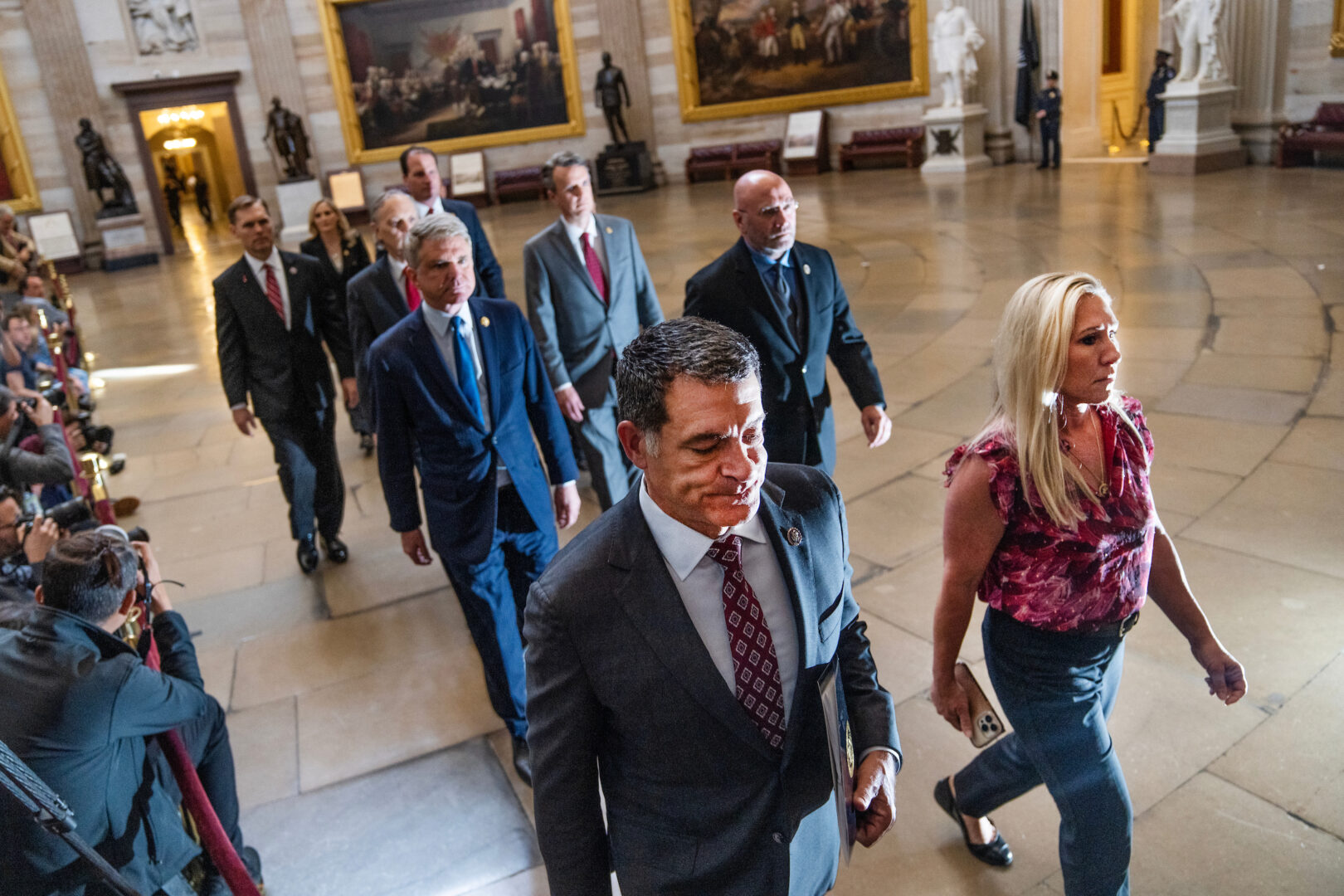 House impeachment managers, led by Reps. Mark E. Green, R-Tenn., and Marjorie Taylor Greene, R-Ga., walk through the Capitol Rotunda on Tuesday to the Senate to deliver articles of impeachment against Homeland Security Secretary Alejandro Mayorkas.