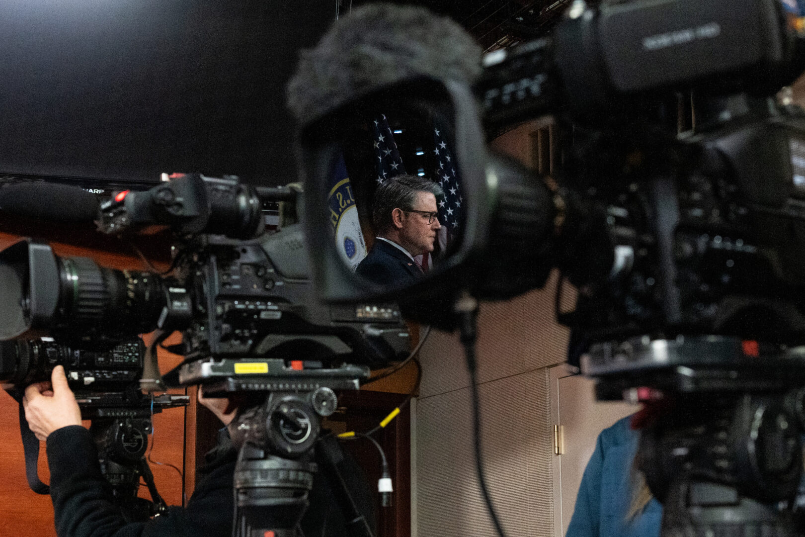 Speaker Mike Johnson is reflected in a video camera lens at the Capitol on Thursday. The Louisiana Republican announced the release of a new tranche of Jan. 6 footage on Friday.