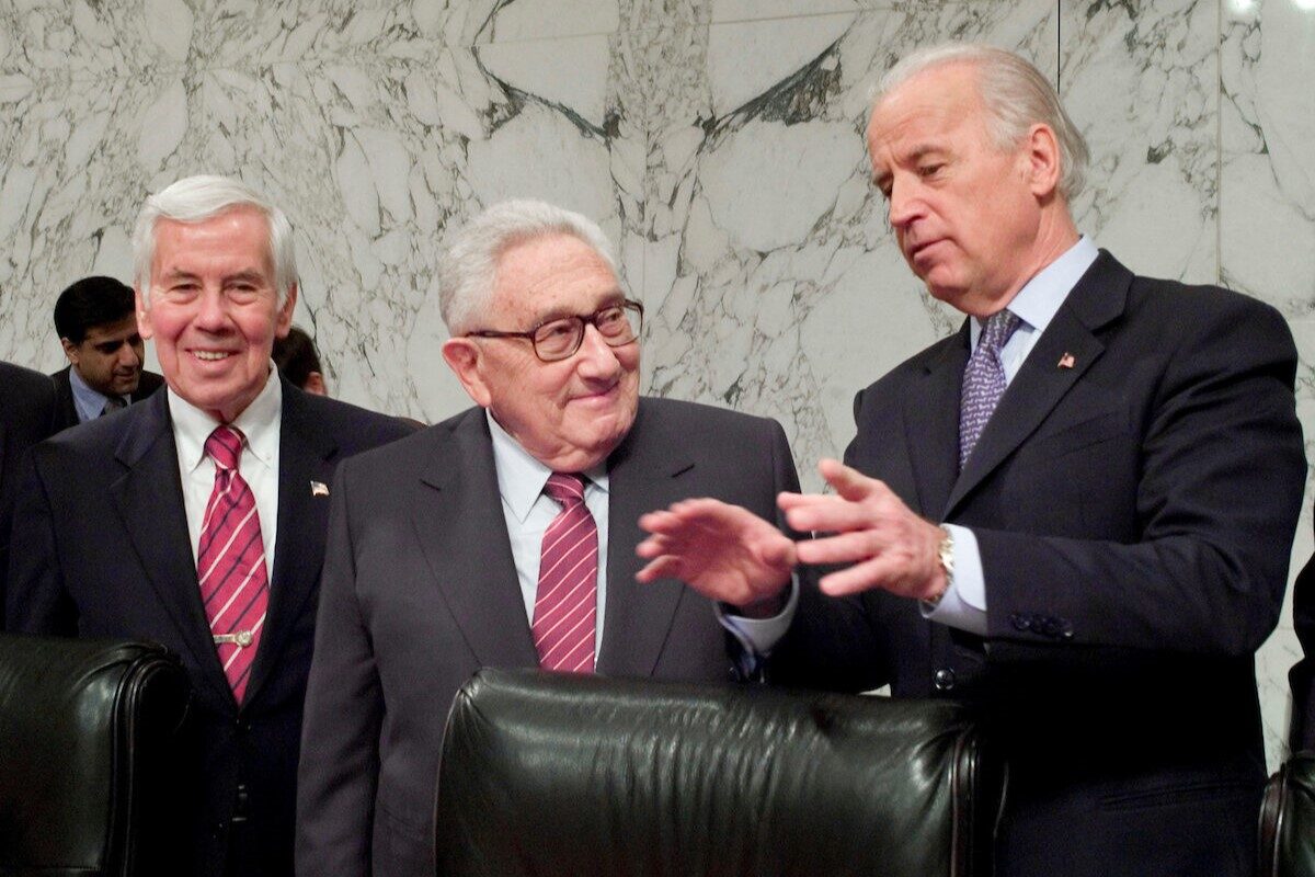 Former Secretary of State Henry Kissinger, center, talks with then-Senate Foreign Relations Chairman Joe Biden, D-Del., right, and ranking member Richard G. Lugar, R-Ind., before a hearing on Jan. 31, 2007. Kissinger died on Wednesday. 