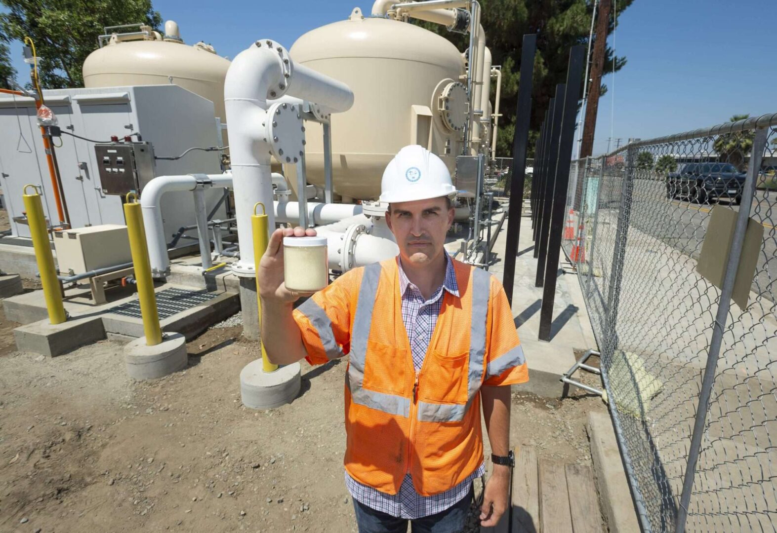 An engineer showed a sample of the ion exchange resin that the Orange County Groundwater Authority uses to remove PFAS chemicals from drinking water at a treatment plant that went online in 2021 in Fullerton, Calif.