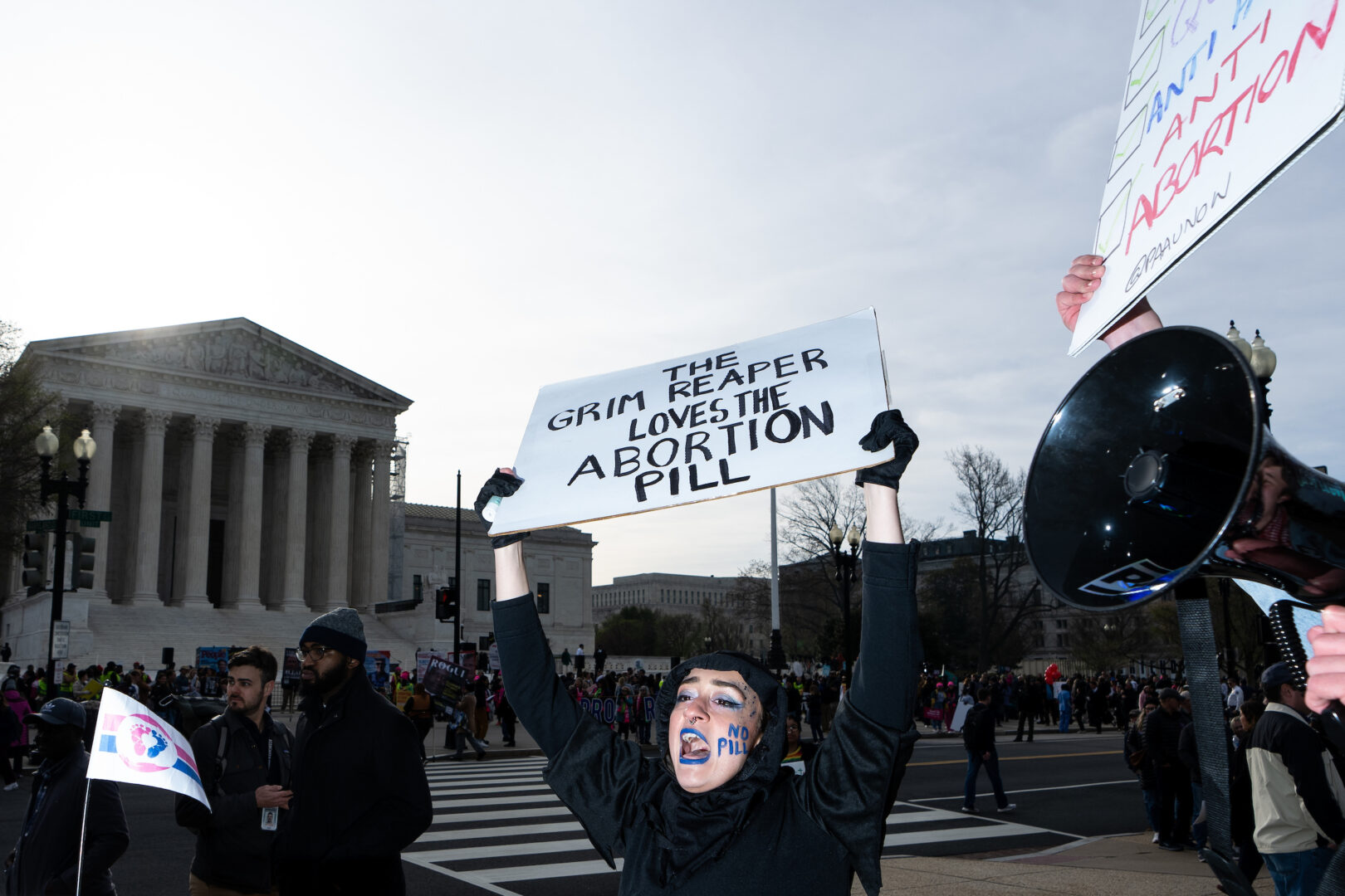 Activists protest at the Supreme Court as the court hears oral arguments in a case about access to mifepristone, the drug used in medication abortions. 