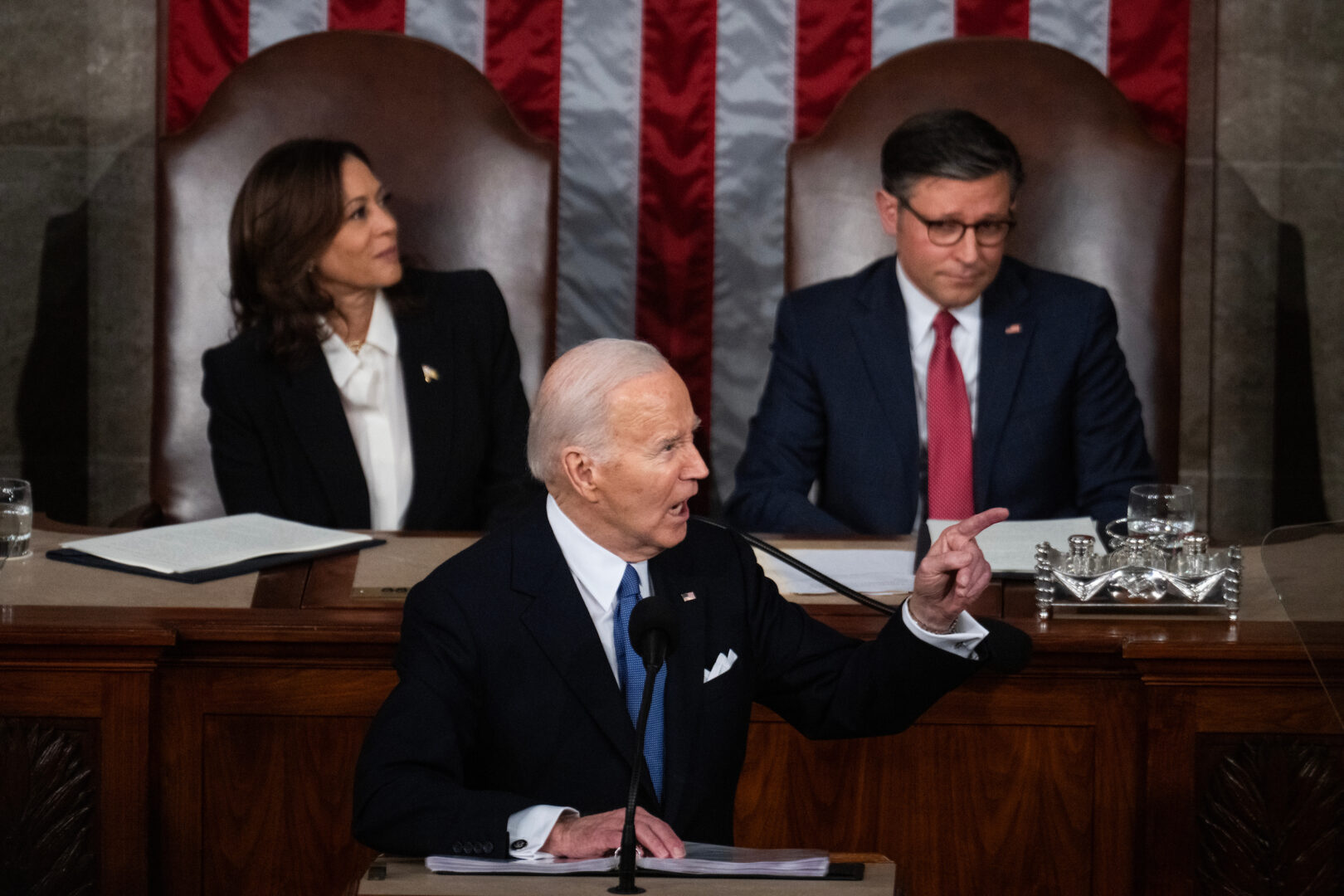 Speaker Mike Johnson, R-La., right, seated next to Vice President Kamala Harris, reacts as President Joe Biden delivers his State of the Union address on March 7.