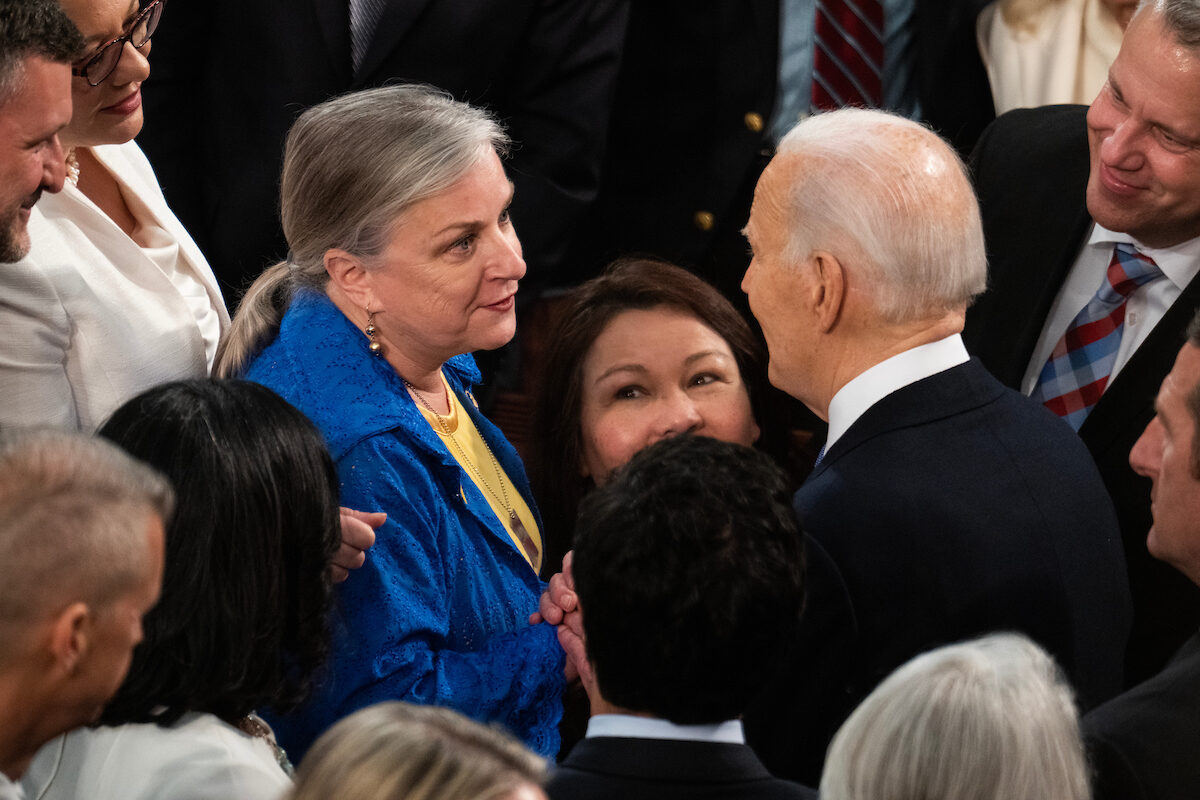 President Joe Biden speaks with Rep. Susan Wild, D-Pa., after his State of the Union address March 7. 