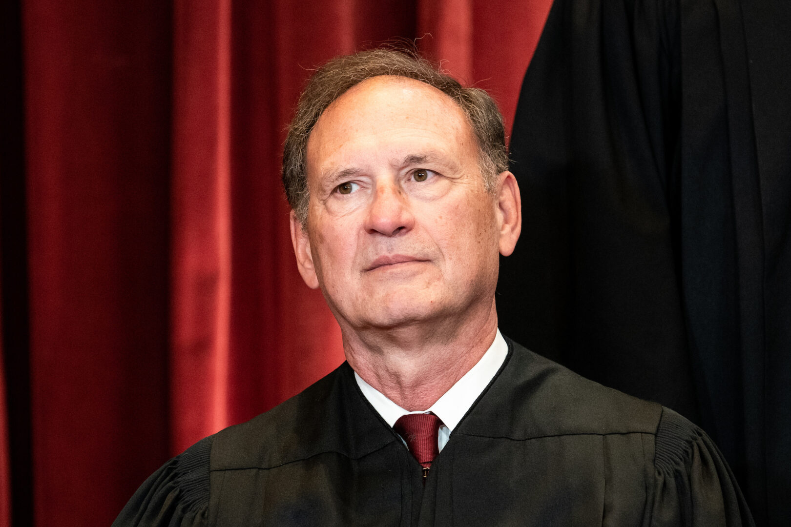 Justice Samuel A. Alito Jr. sits during a group photo of the justices at the Supreme Court. 